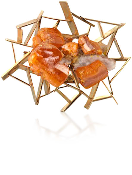 John Donald, Brooch of 9ct yellow gold irregular panels, set at angles, holding a natural crystal of
orange wulfenite