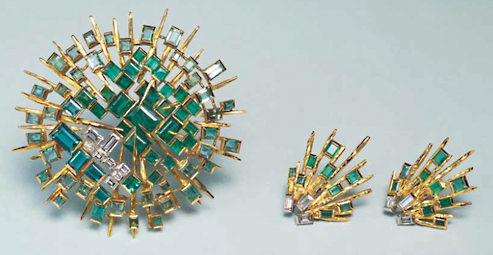 John Donald, Concave brooch of 18ct yellow gold radiating rods with dark emeralds set in centre
